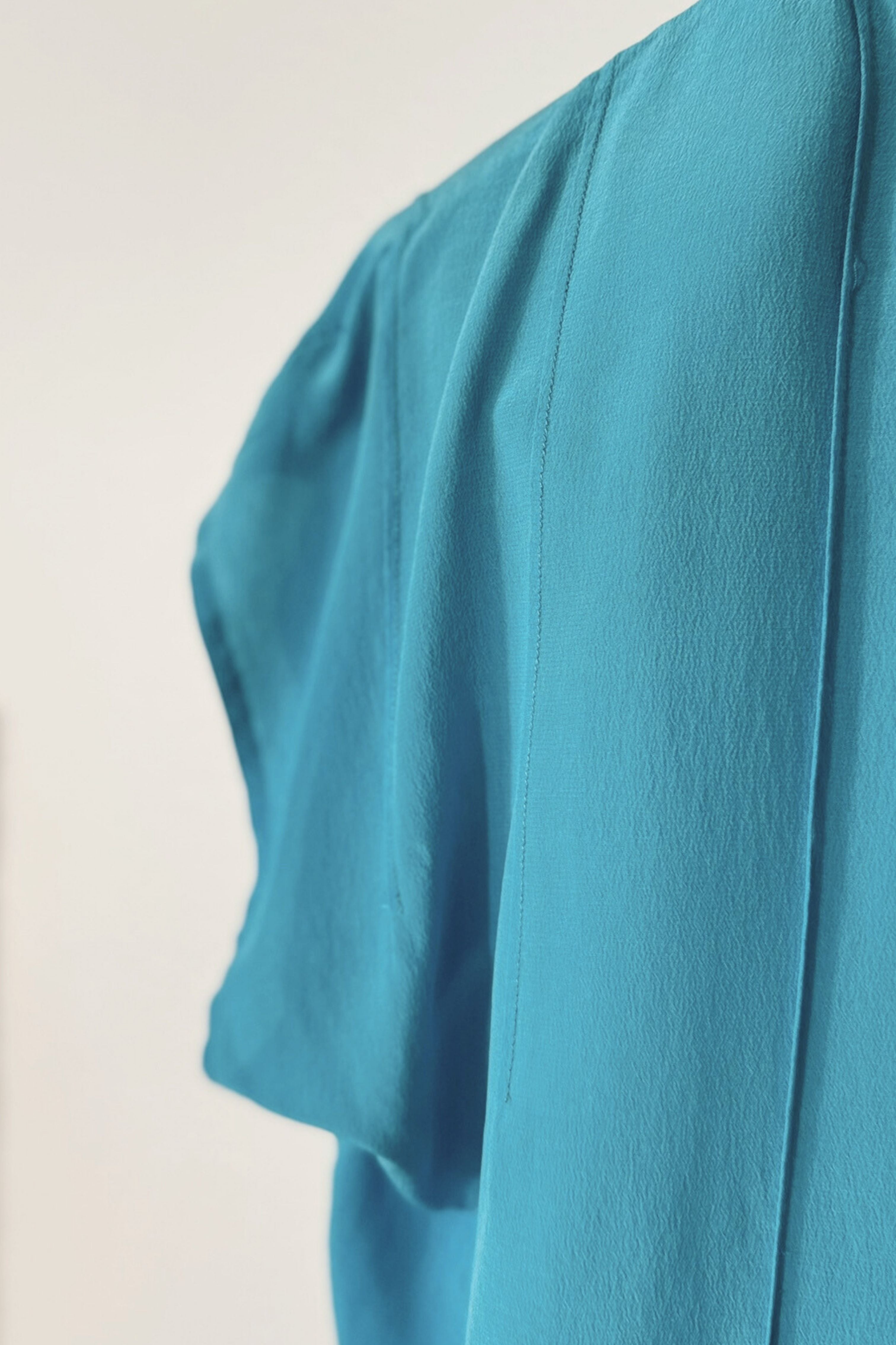 Blouse surpiquée en soie turquoise
